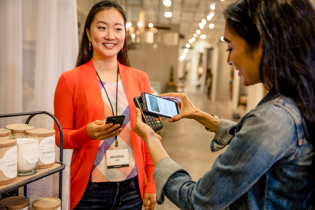Woman is making a card payment in a retail shop